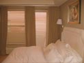 Wood blinds and drapes for bedroom windows in Manhattan, NY