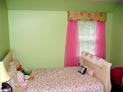 Wood blinds, cornice and sheer drapes in children�s bedroom in Westchester, New York