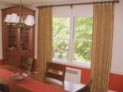 Pinch pleated curtain on decorative hardware for dining room window in Westchester, NY