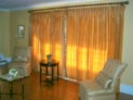 Silk drapes on decorative hardware for large living room sliding doors in Long Island, New York