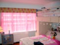 Sheer drapes along with a straight cornice for kid�s bedroom in New York City