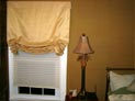 Relaxed roman and pleated shade for bedroom window in Long Island, New York