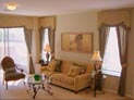 Shaped cornice and tied back side panels for living room windows and large sliding door in New York