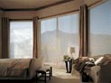 Hunter Douglas Luminette shades with side panels in bedroom
