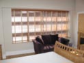 Wood blinds with taping for bedroom windows in Brooklyn, NY