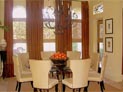 Woven wood shades and drapes in dining room
